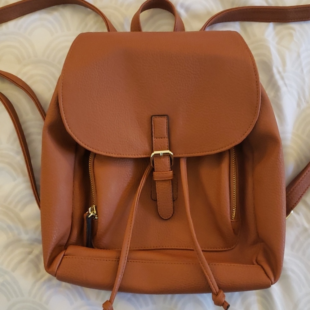 Mini brown leather backpack.